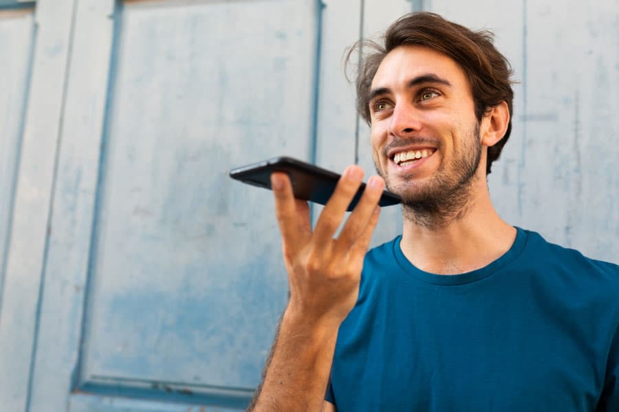 Young man talking to its smartphone, looking for local businesses