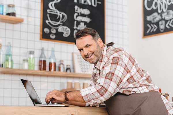 A small local business owner working on his computer, running a local SEO campaign