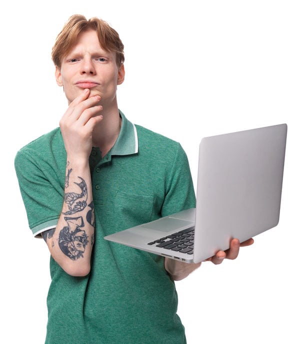 image of a young man confused about the indexability of his website, with a computer and wearing a green t-shirt